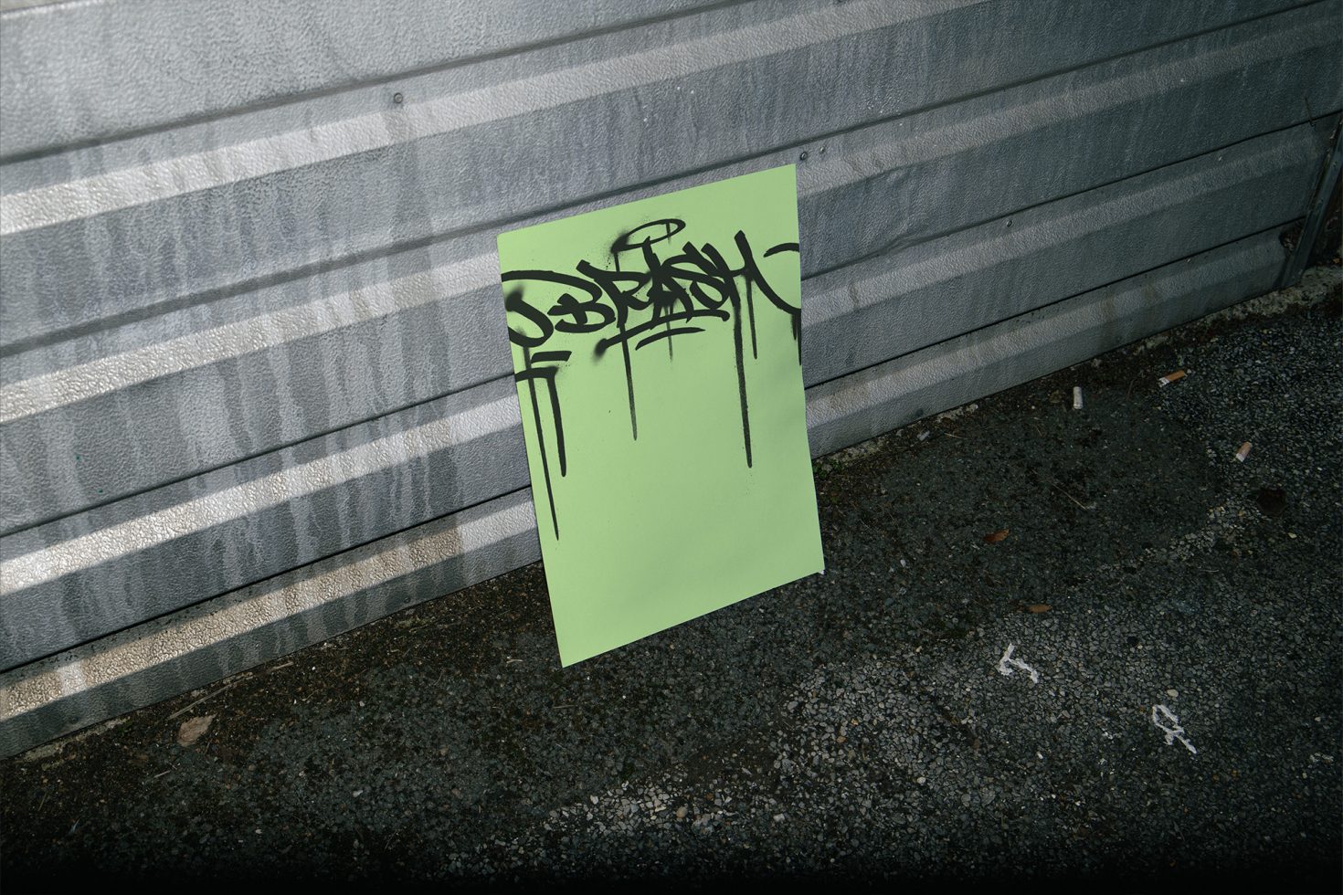 Neon green poster with black graffiti on urban background for mockup design, showcasing street art style suitable as graphic overlay or template.